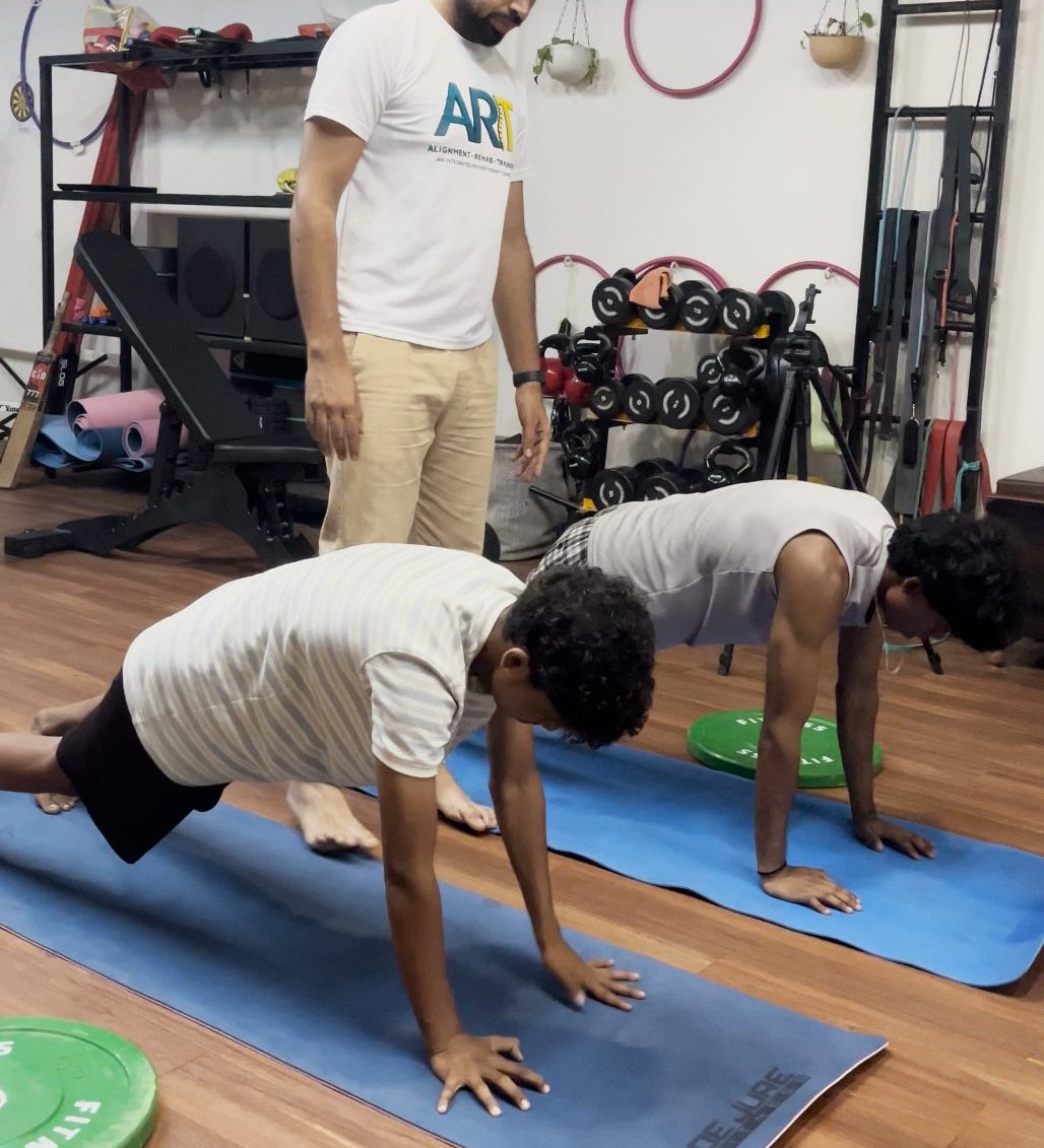 ART physiotherapist coaching patients through core strengthening exercises at the Sector 58 clinic