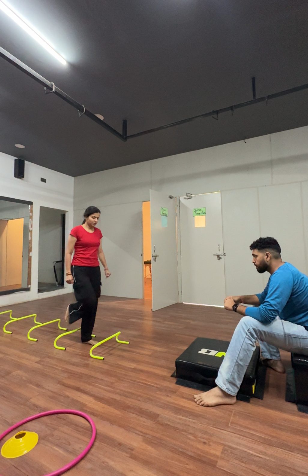 Athlete doing agility hurdle drills during sports rehab