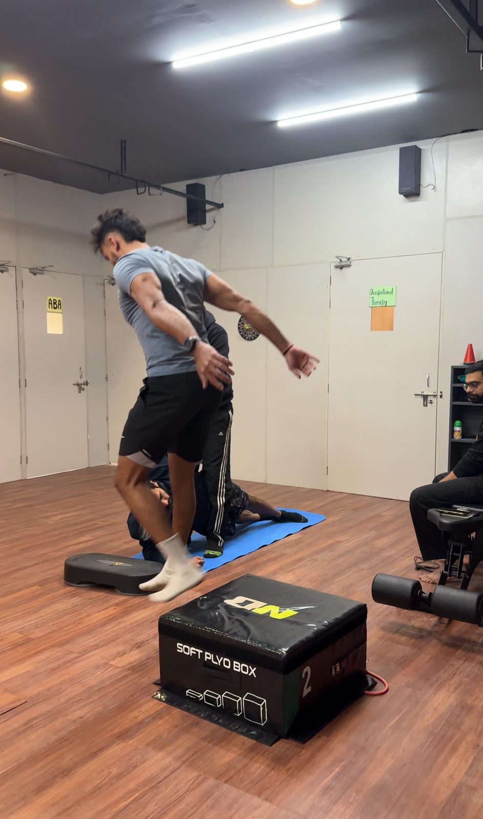 Athlete performing a plyometric box jump during ACL rehab