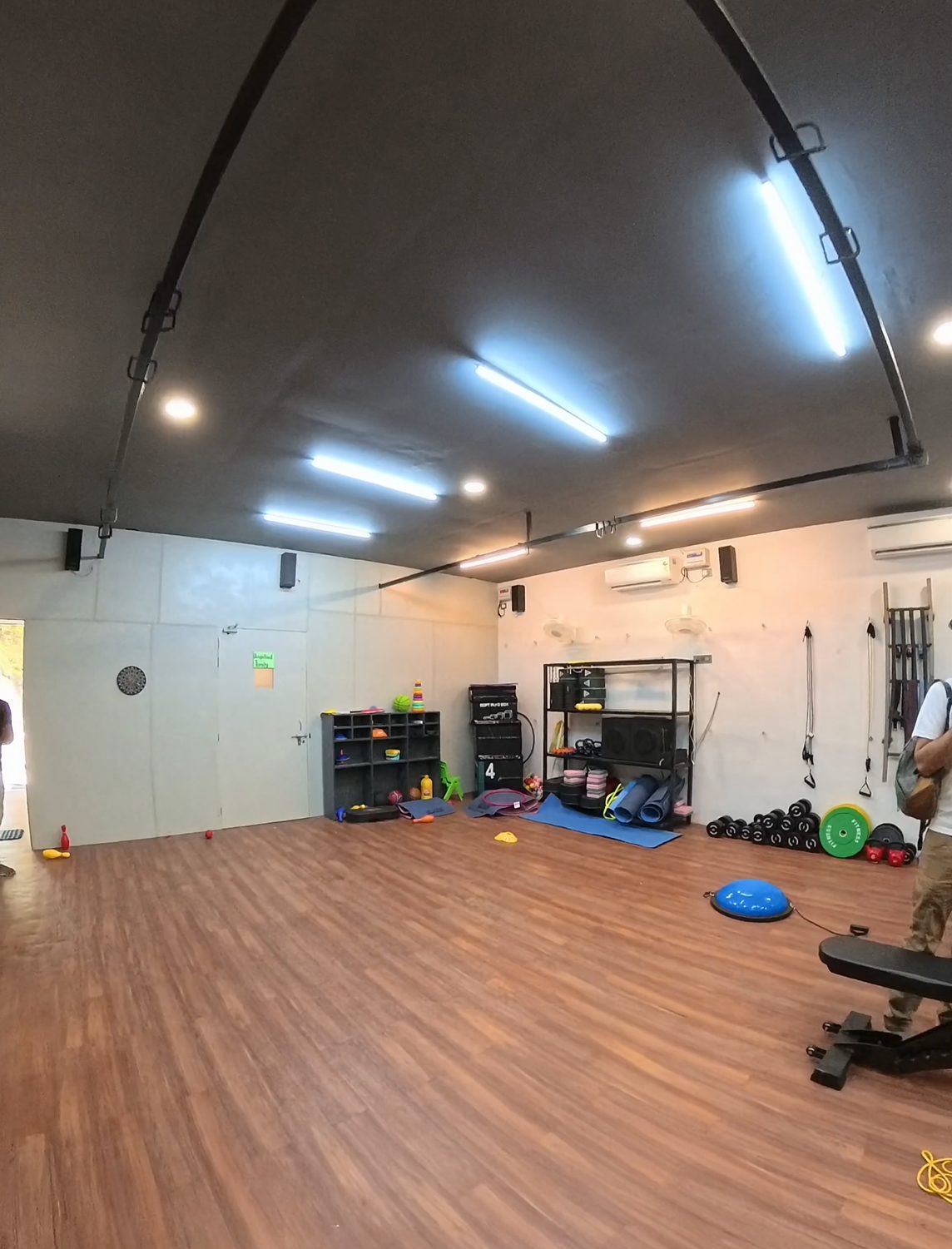 Spacious indoor rehab training hall with wooden flooring