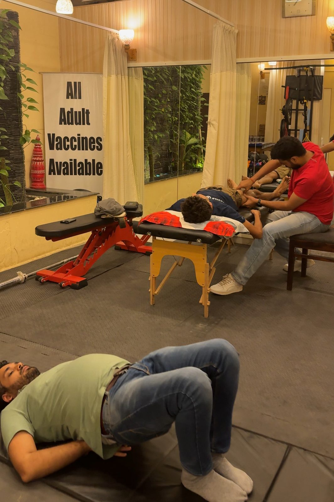 Therapist giving one-on-one treatment while a patient does a bridge exercise